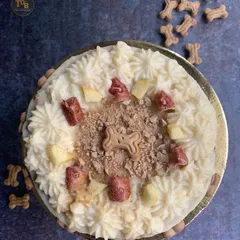 A top-down view of this delicious dog cake, showing off all the yummy toppings. I use fresh apples, a sprinkle of carob powder, and creamy frosting to make every bite exciting for your furry friend.