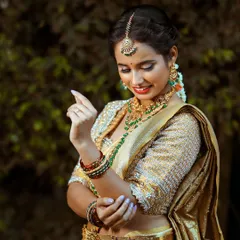 The intricate details of the golden saree and the matching temple jewellery create a breathtaking bridal look.