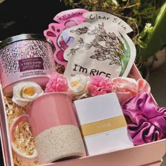 The "Scent of Love" hamper is a perfect gift for her. It features a large 3-wick candle from Bath & Body Works, a Zara mini perfume, face sheet masks, a coffee mug, and scrunchies.