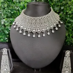 This American Diamond set features a wide, intricate choker and long, dramatic earrings, designed to make a bold statement at any evening event.