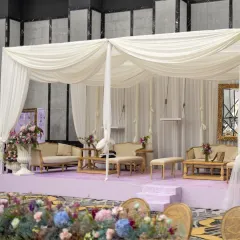 A serene and sophisticated lounge area. I used soft white drapes to create a canopy over plush seating, all set on a lavender stage for a look that is both calming and incredibly chic.