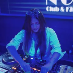 Focused at the console during a packed club night. My process involves carefully reading the room and blending tracks to build a seamless, high energy set.
