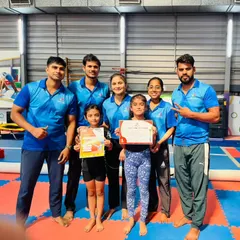 Our amazing team of coaches celebrating with two of our students. It's a team effort to help our little stars shine.