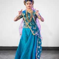 As Radha, every gesture is filled with meaning. This pose, with hands held in a specific mudra, conveys a sense of devotion and surrender, central to the character's relationship with Krishna.