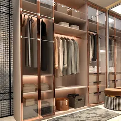 This is where organization meets artistry. We designed this walk-in wardrobe with rose-gold glass and integrated lighting to feel like a personal boutique. Every shirt, accessory, and pair of shoes has its own place, turning the daily routine of getting dressed into a moment of quiet luxury.