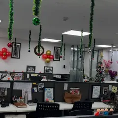 Simple yet effective Christmas decor for an open-plan office. We used hanging green tinsel with festive baubles and subtle balloon clusters to bring holiday cheer to the workspace without disrupting the professional environment.