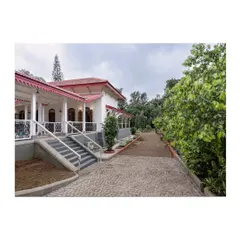 The restored cobblestone driveway leading up to the heritage structure. The landscaping and exterior restoration work together to create a cohesive and stately approach to the property.