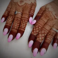 A full view of this pink ombre bridal set, showing how the nails look against the beautiful, dark henna stain.