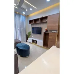 A look at the completed 3BHK interior project in Gurgaon. This is the living room, featuring a custom TV unit with open shelving and concealed storage.