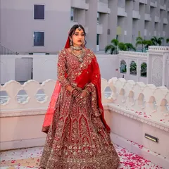 A full view of the classic red bridal lehenga. My makeup is designed to complement the grandeur of the outfit, creating a cohesive and breathtaking royal bridal look.
