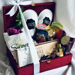 The ultimate bridal hamper, curated to pamper the bride-to-be. This luxurious red velvet keepsake box is filled with personalized slippers, a custom towel, gourmet chocolates, and premium skincare, making it the perfect gift for her big day.