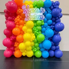 For a 'Women in Business' conference, we designed this vibrant rainbow balloon wall with a custom branded sign. This backdrop served as a powerful visual centerpiece and a popular spot for photos.