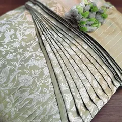 A beautiful pastel Banarasi saree, pre-pleated and box-folded. Handling the rich brocade of a Banarasi requires care, and my service ensures it's done right.