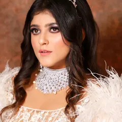 For a glamorous evening look, this client chose an eye-catching American Diamond choker to go with her white feathered outfit. A true statement piece for any party.