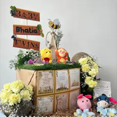 A journey into the Hundred Acre Wood to welcome the Bhatia twins. This charming Winnie the Pooh hamper is filled with character plushies, storybook quotes, and sweet treats, all nestled in a rustic, garden-like setting.