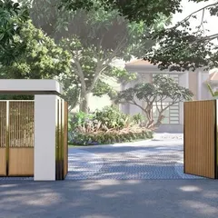 The entrance to this villa makes a statement with clean lines, a combination of solid and latticed walls, and elegant wooden gates, setting a tone of modern sophistication.