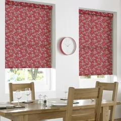 These red roller blinds with a subtle grey leaf pattern add a pop of color to this dining room. They are a great way to introduce color and design while maintaining a clean, modern look.