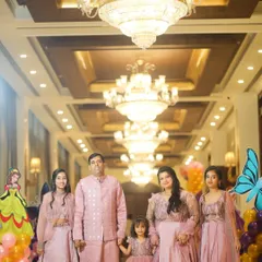 A beautiful family dressed in coordinated pink outfits for a fifth birthday party. I specialize in capturing elegant portraits at indoor venues, using the location's ambiance to create stunning images.