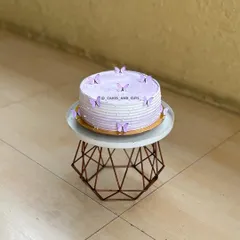 The full view of the lavender butterfly cake on its stand, a perfect design for any girl's birthday.