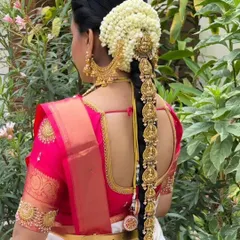 A close-up of the beautiful 'Jade Bangara' hair ornament, intricately designed with temple motifs to match the main jewellery set. We rent these out to complete your bridal look.