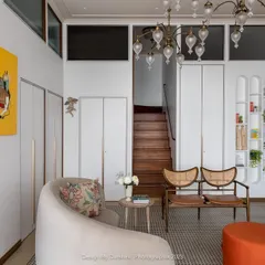 Designing a clinic requires a delicate balance between luxury and tranquility. In this waiting lounge for Ra Clinic, I used a base of soft, neutral tones and clean lines, then introduced pops of vibrant color through the client's personal art collection. The result is a space that feels more like a serene, upscale living room than a clinical waiting area.