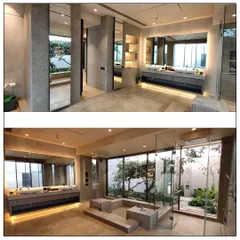 This bathroom blurs the line between indoors and outdoors, creating a private spa experience. The design incorporates a sunken jacuzzi, dual vanities, and a glass wall that opens to a secluded garden, allowing our client to connect with nature while enjoying modern comforts.