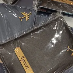 A collection of customized passport covers in premium leatherette, each with a nameplate and a charm. A perfect personalized gift for travelers.