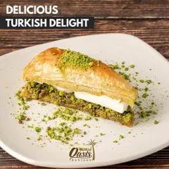 A slice of our delicious Turkish delight, a variation of baklava with a creamy filling sandwiched between layers of nutty pastry.