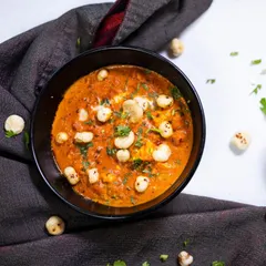 A comforting bowl of our Paneer Makhana Masala. This dish combines soft paneer cubes and crunchy lotus seeds in a velvety, tomato-based gravy for a unique texture and taste.
