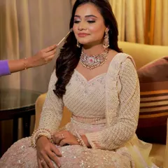 Adding a touch of color. Here I am applying blush to give the bride a natural, healthy glow for her reception.