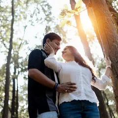 A sun-kissed moment in the woods. The low angle and the flare from the sun create a warm, romantic, and natural feel for this couple's portrait.