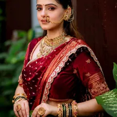 For this beautiful Navari look, I created an ultimate soft glam style. The focus is on flawless skin, subtly enhanced eyes, and letting the magnificent jewelry, like the nath and layered necklaces, take center stage against the rich maroon velvet saree.