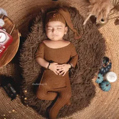 An overhead shot of a sleeping baby in our rustic, boho-inspired setup with a vintage radio prop.