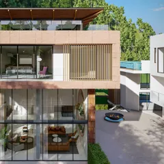 This view shows the home's extensive use of glass, which opens up the interiors to the surrounding forest. The design creates a harmonious blend of architecture and nature, with earthy materials like stone and wood used throughout.