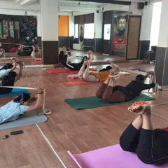 Props are tools for empowerment. Here, my students are using yoga straps in Dhanurasana, the Bow Pose, to get a better lift and a deeper backbend. This technique helps open the shoulders and chest while protecting the lower back.