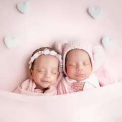 To the most adorable duo. Tucked in together under a soft pink blanket, these twin girls look so peaceful and content.