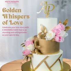 This three-tier wedding cake is a study in modern luxury, blending clean lines with opulent details. It features a striking brushed gold middle tier, geometric gold accents, and is softened by clusters of fresh pink and white roses, all personalized with the couple's monogram.