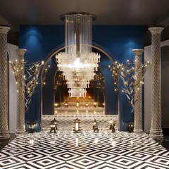 An ambiance of grandeur and luxury. This is a reception area we designed for a light showroom, featuring a dramatic entryway with classical pillars, a massive chandelier, and bold geometric flooring.