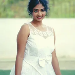 A client looking angelic in a simple white sleeveless gown. This is a perfect rental for a daytime event, a photoshoot, or a themed party.