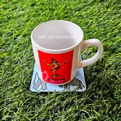A coaster in action! They are printed on MDF, laser-cut, and the top surface is waterproof, making them as practical as they are beautiful.