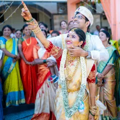 A joyous moment as the newly married couple looks towards their future together, surrounded by the love of their family and friends.