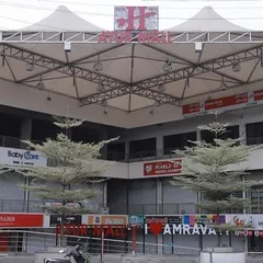 A closer look at the entrance and facade of Ayur Mall. The design strategically uses landscaping and open frontage to create a seamless transition from the street to the commercial spaces within, enhancing the building's accessibility.