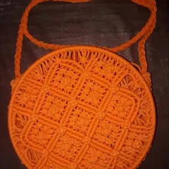 For those who want something a little different, I also make these Macrame Ring Bags. This one in bright orange has a unique circular design and intricate knotting, making it a real statement piece for any occasion.