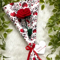 A single red rose wrapped in cute heart-patterned paper, with a little "Happy Anniversary" tag. It’s the small, personal touches that make a gift special.