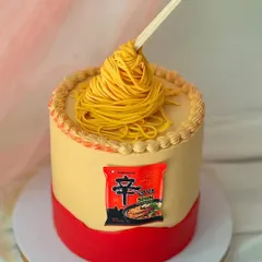 A cake for the instant noodle lover. This design replicates a bowl of Shin Ramyun, complete with fondant noodles held up by chopsticks for a gravity-defying effect.