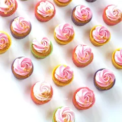 Simple and pretty pink swirl cupcakes in assorted colourful liners. I add a sprinkle of edible gold flakes to each one for a touch of elegance.