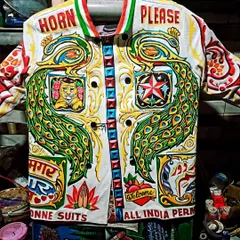 A true celebration of Indian truck art on a jacket. This piece is packed with iconic elements like the 'Horn Please' slogan, majestic peacocks, and multi-lingual text, all hand-painted in dazzling colors. It’s a wearable piece of desi pop culture.