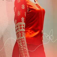 A detailed shot of the sleeve of our red velvet kurta. The intricate zardosi and threadwork create a beautiful, traditional pattern, making this a standout feature of the ensemble.