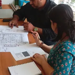Two of our team members reviewing architectural drawings together. This hands-on, collaborative approach ensures that every detail is carefully considered and integrated into the overall design.
