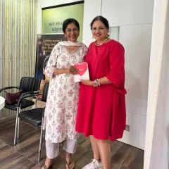 It's a joy to connect with my patients. Here I am with a client, sharing a special giveaway hamper.